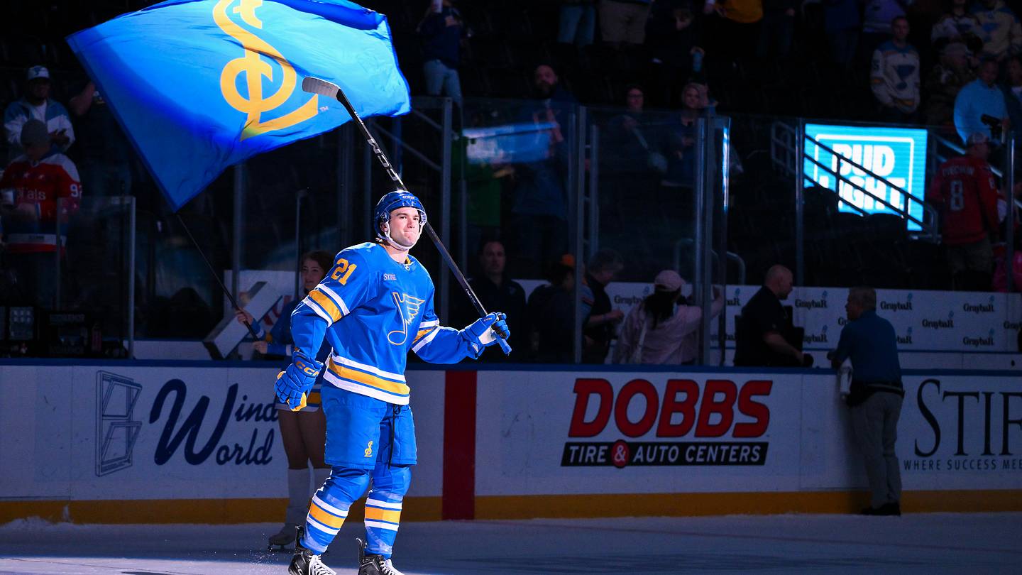 Mar 24, 2026; St. Louis, Missouri, USA; St. Louis Blues right wing Jimmy Snuggerud (21) salutes the fans after he was named second star of the game after a victory over the Washington Capitals at Enterprise Center. Mandatory Credit: Jeff Curry-Imagn Images
