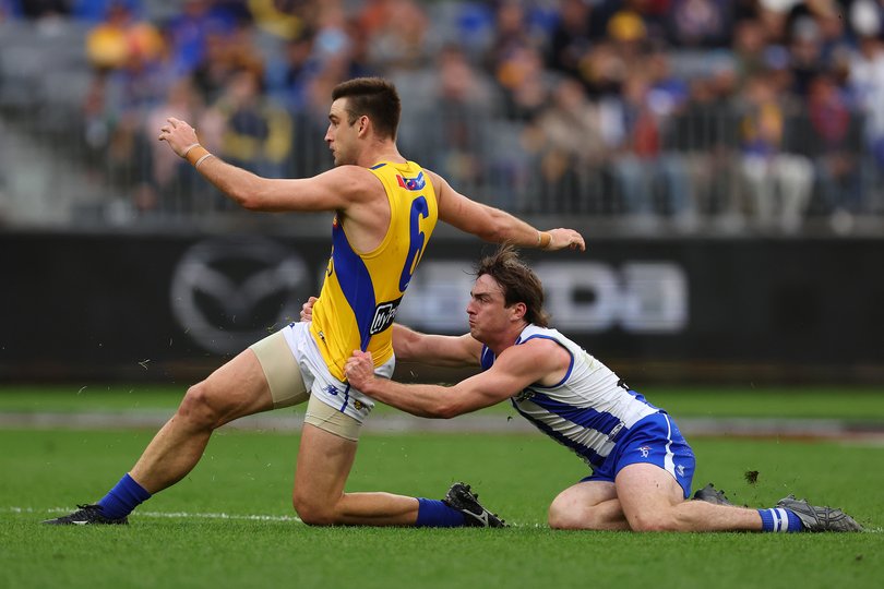 George Wardlaw of the Kangaroos tackles Elliot Yeo.