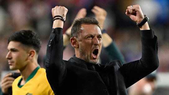 Tony Popovic celebrates as Australia go through to the knockout stage of the World Cup.