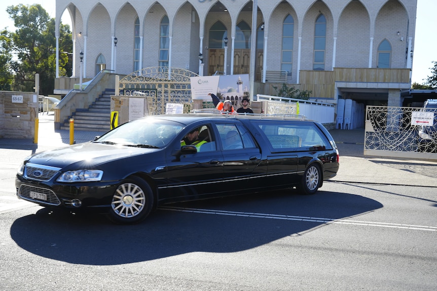 A hearse carrying Lorenzo Lemalu leaves Lakemba Mosque