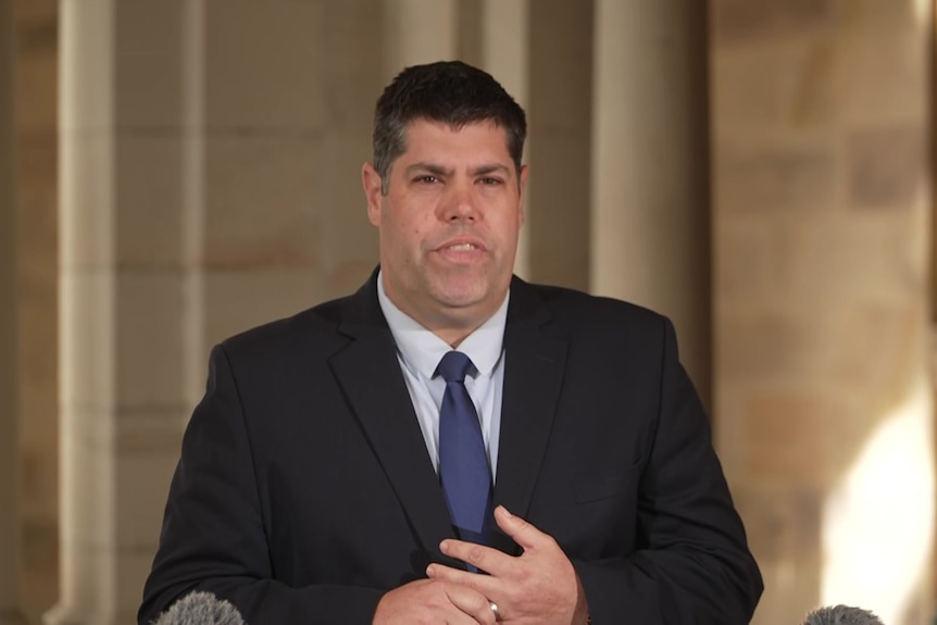 Brent Mickelberg at a press conference.