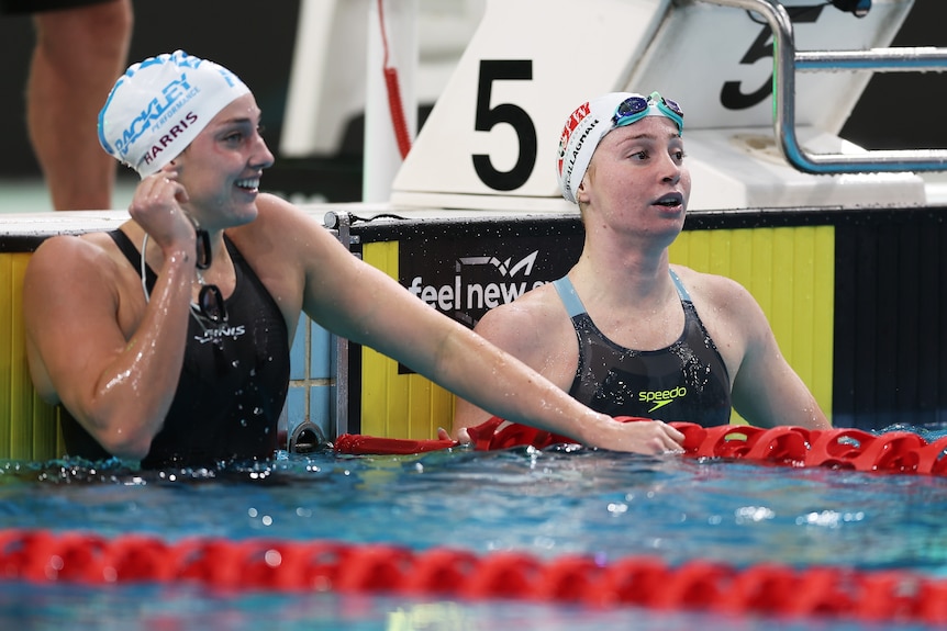Meg Harris and Mollie O'Callaghan in the water after the 100m freestyle.