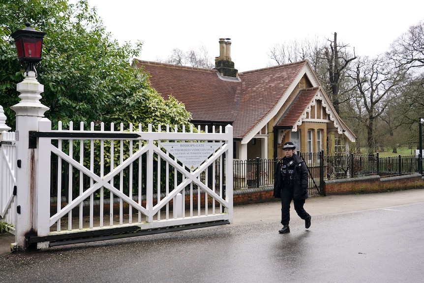 A police officer passes the gate of the Royal Lodge in Windsor.