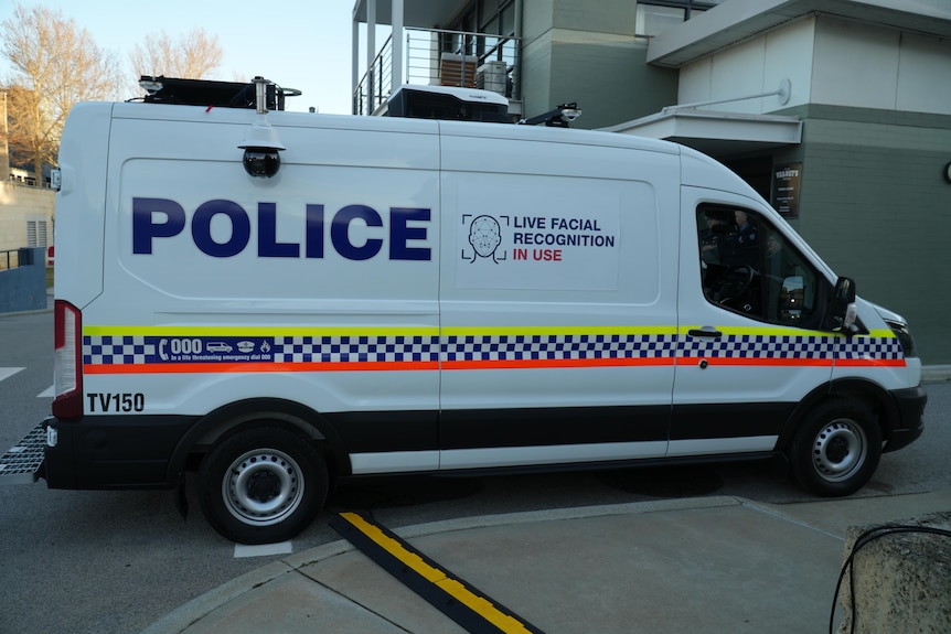A white WA Police van with a sign on the side reading 'live facial recognition in use'.
