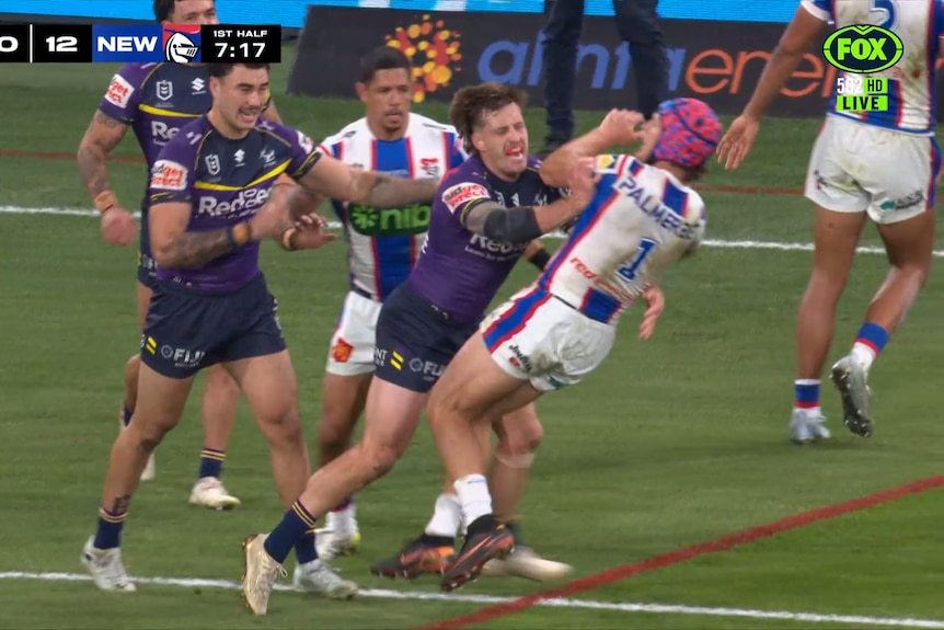 Cameron Munster shoves Kalyn Ponga during an NRL game between the Melbourne Storm and the Newcastle Knights.