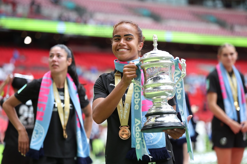 Mary Fowler holds up the Women's FA Cup trophy.