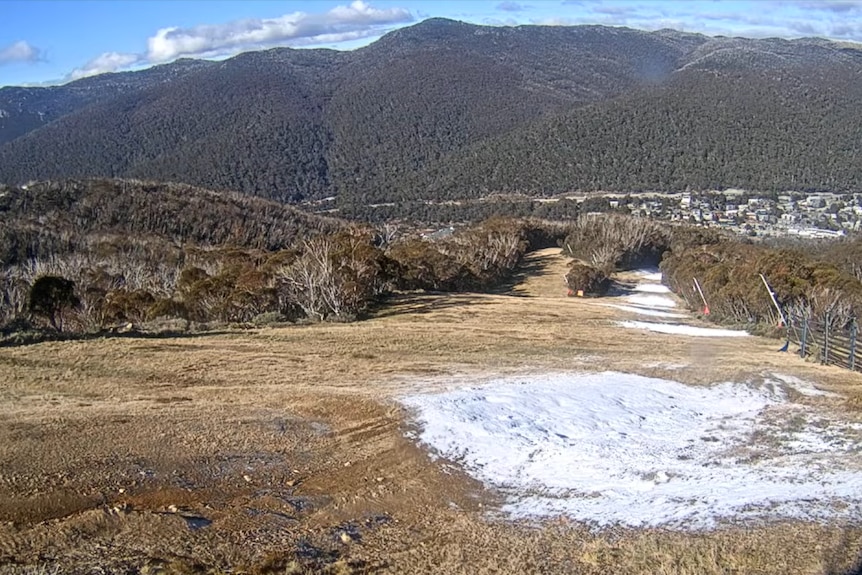 ski slopes with only a splattering of snow cover