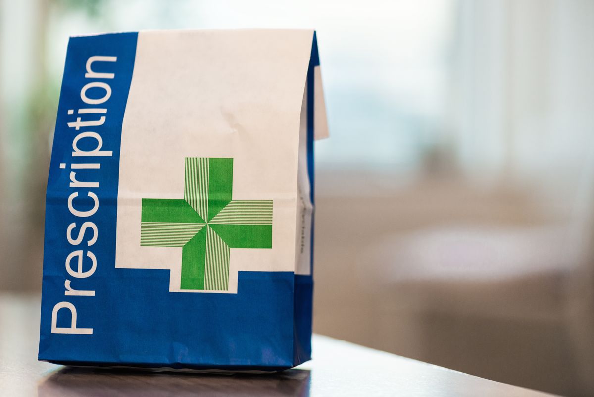 A close-up image of a paper bag containing prescribed medical items.