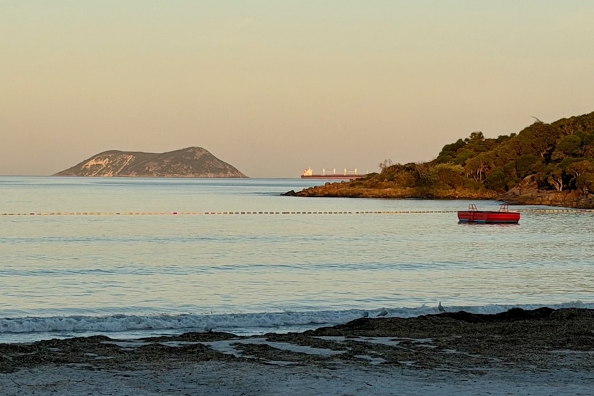 View of an island in the distance with beach in foreground