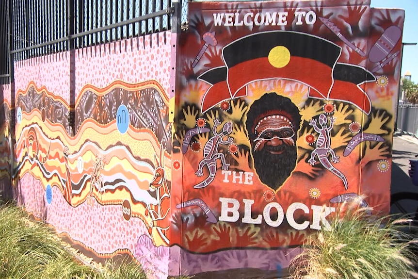 a mural at redfern that reads welcome to the block