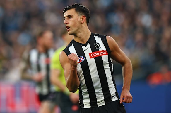 Nick Daicos of the Magpies celebrates kicking a goal.