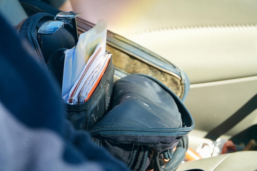 A close-up of documents in a backpack.