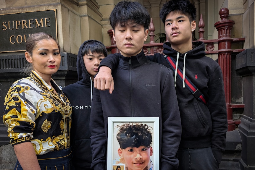 The family of killed teen Ethan Hoac hold his photo outside the Supreme Court of Victoria