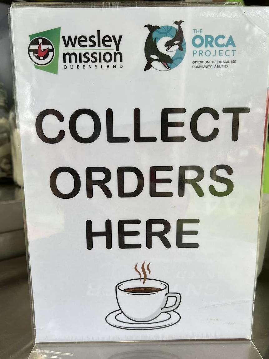 A sign that says, 'Collect orders here'. It also has the ORCA Project and Wesley Mission Queensland logos on it.