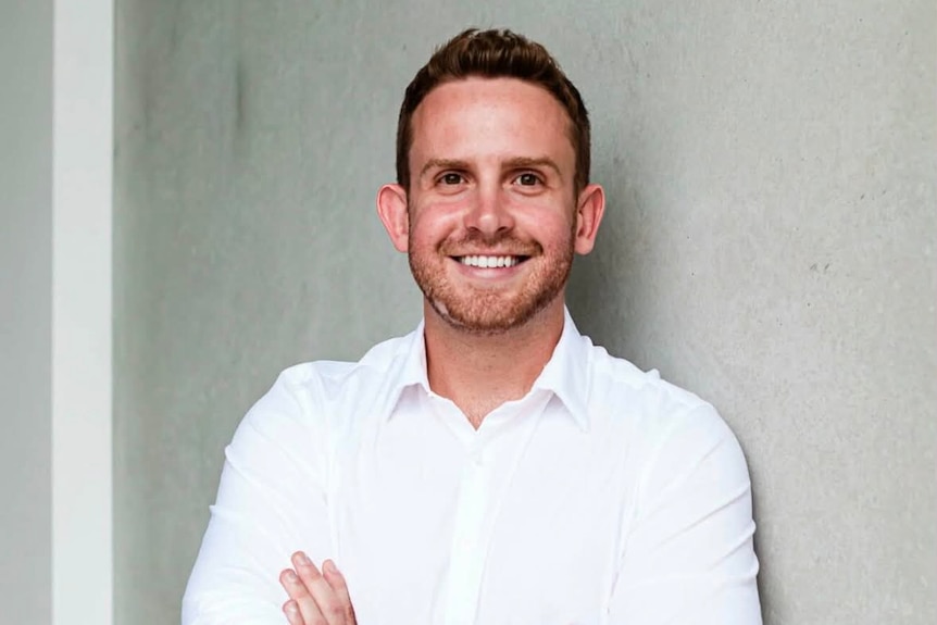 A 30-year-old man smiling at the camera