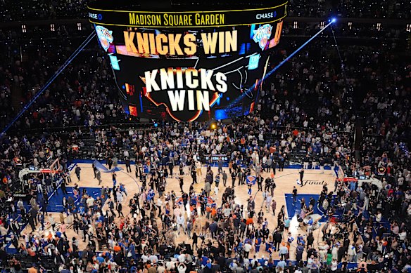 Players and fans celebrate after the New York Knicks’ game four win over San Antonio.