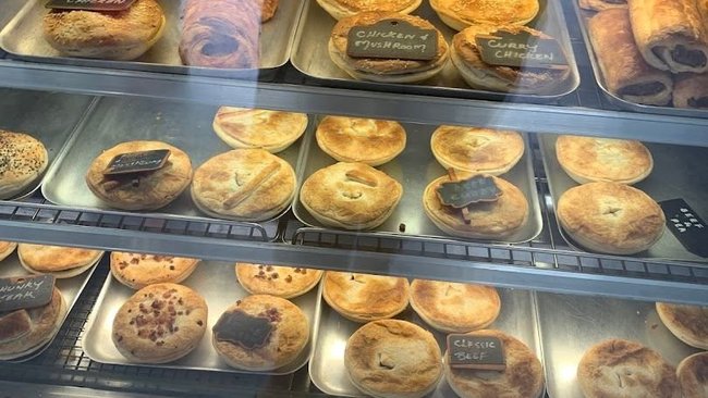 Fresh pies, pastries and sausage rolls on display.