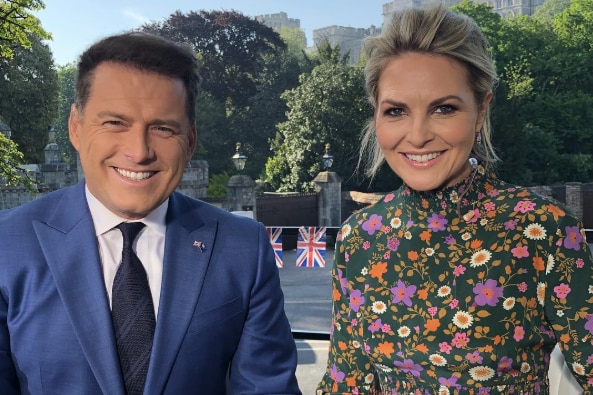 A smiling picture in a UK street with Stefanovic in a blue suit and Gardner in a floral dress.
