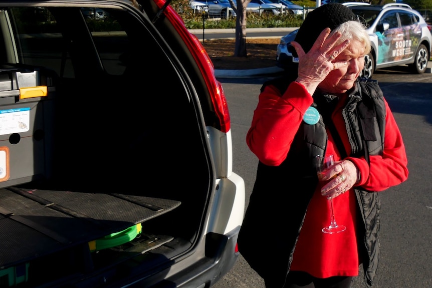 A woman wipes a tear from the eye