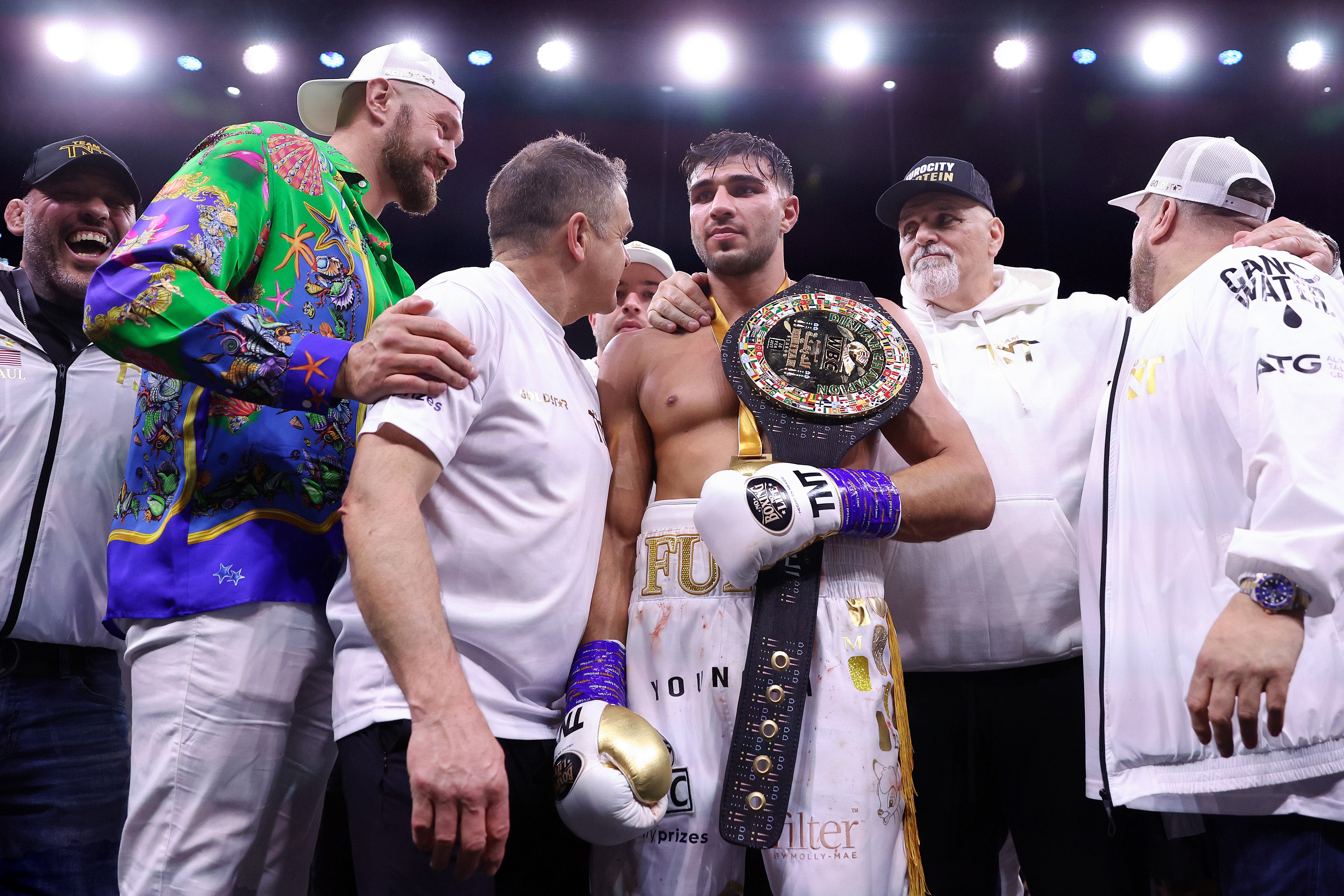 Tommy Fury with half-brother Tyson (left) and father John (right) in 2023