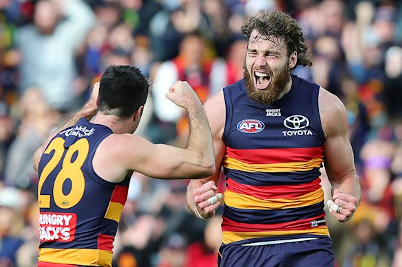 Riley Thilthorpe of the Crows celebrates a goal with Alex Neal-Bullen.