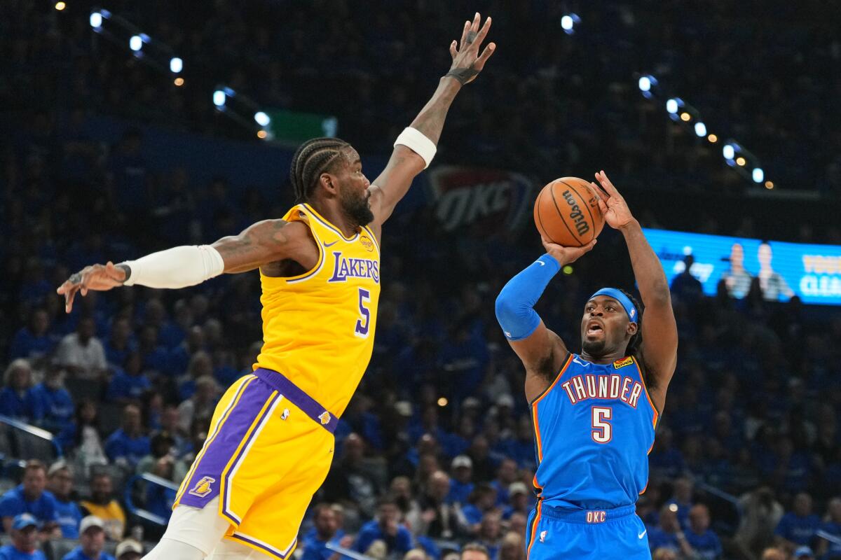 Deandre Ayton defends against Oklahoma City Thunder guard Luguentz Dort during the playoffs.