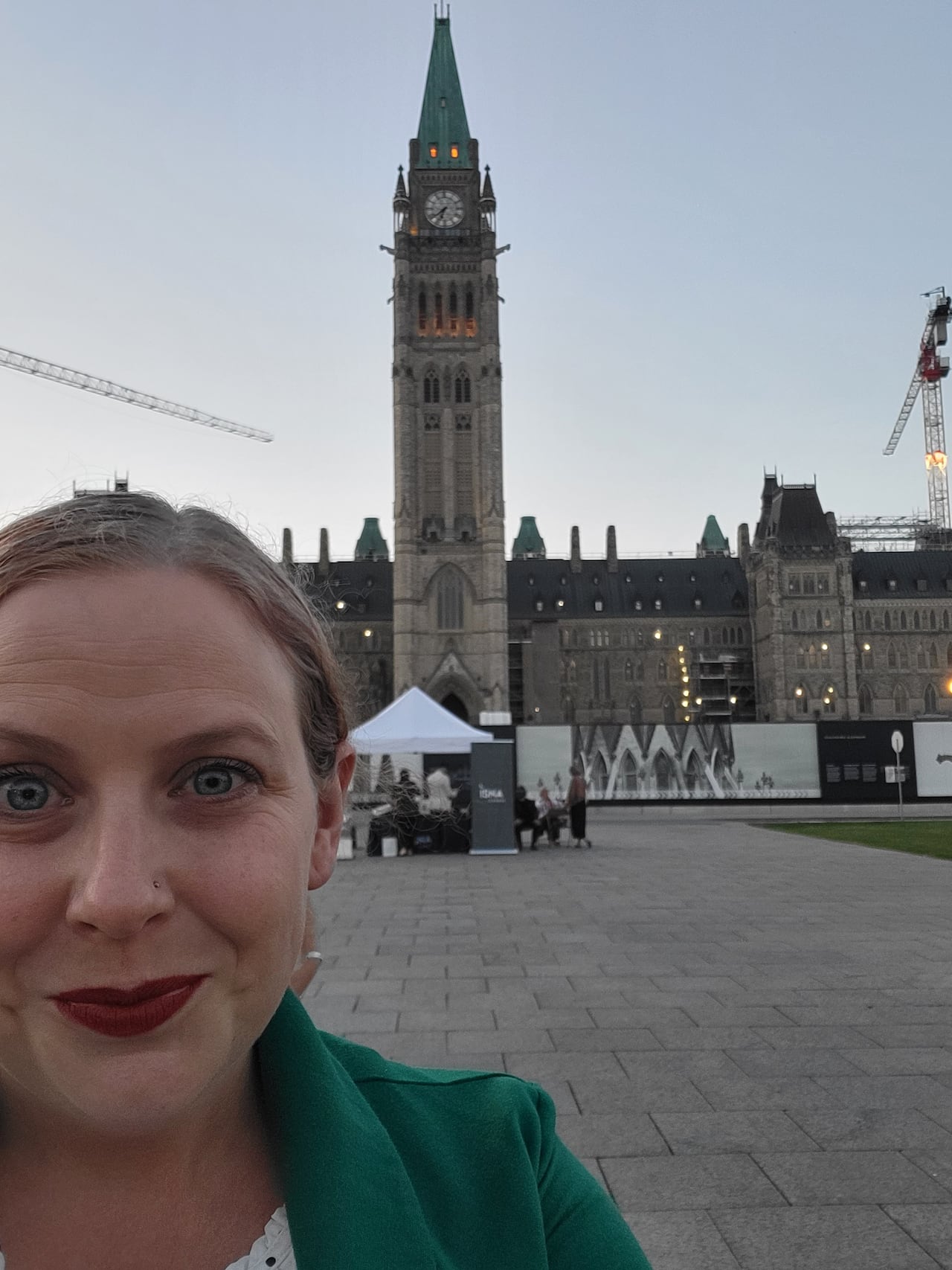 Kelly Favro stands in front of the House of Commons.