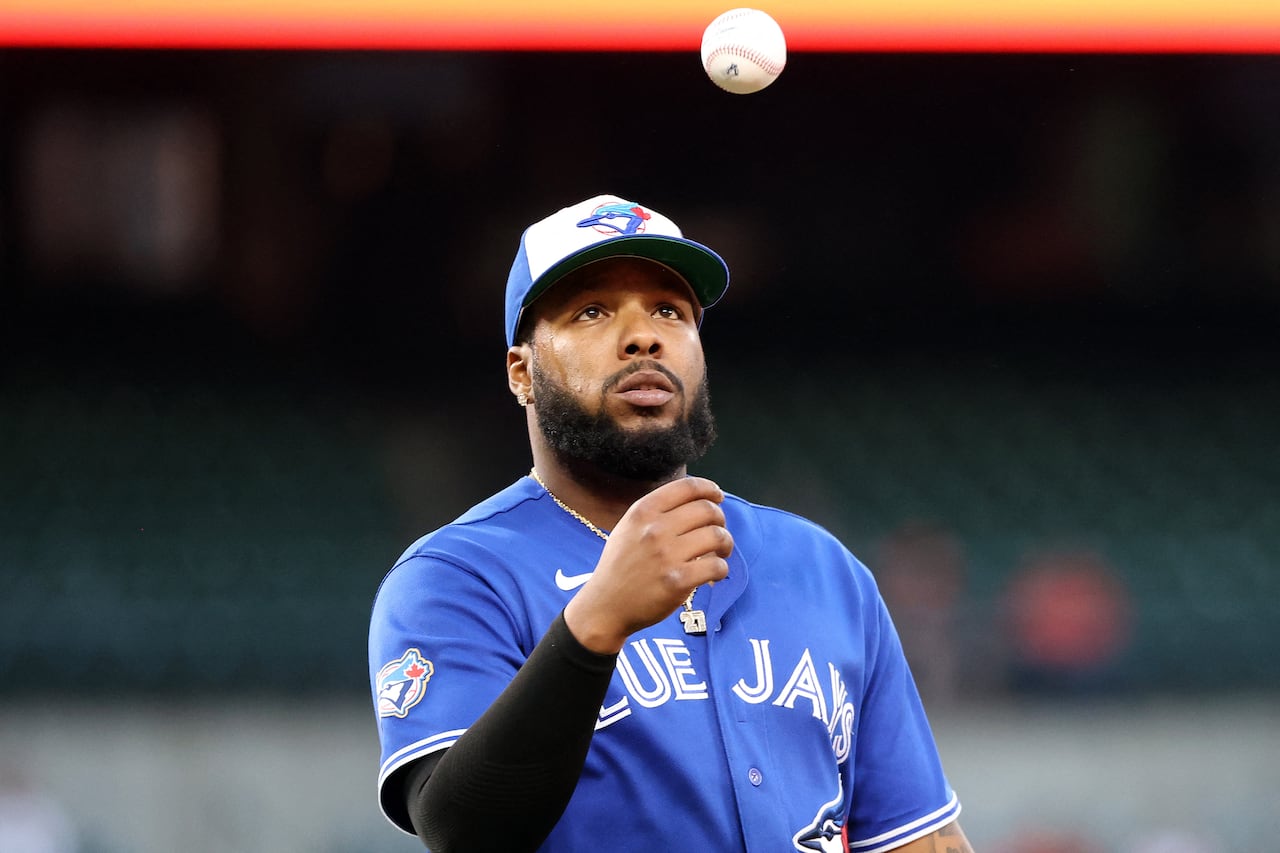 Blue Jays first baseman Vladimir Guerrero Jr. looking toward a baseball, that is in the air.