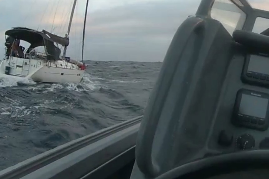 A white yacht to left of screen on the ocean
