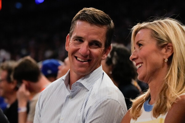 Former New York Giants quarterback Eli Manning watches courtside during Game 3 of the NBA Finals basketball series between the San Antonio Spurs and the New York Knicks, Monday, June 8, 2026, in New York. (AP Photo/Ross D. Franklin)