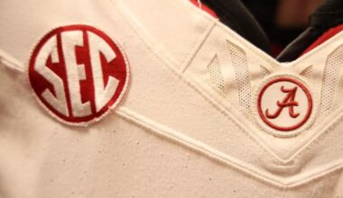 Footballs in front of a gym bag with Alabama on the side