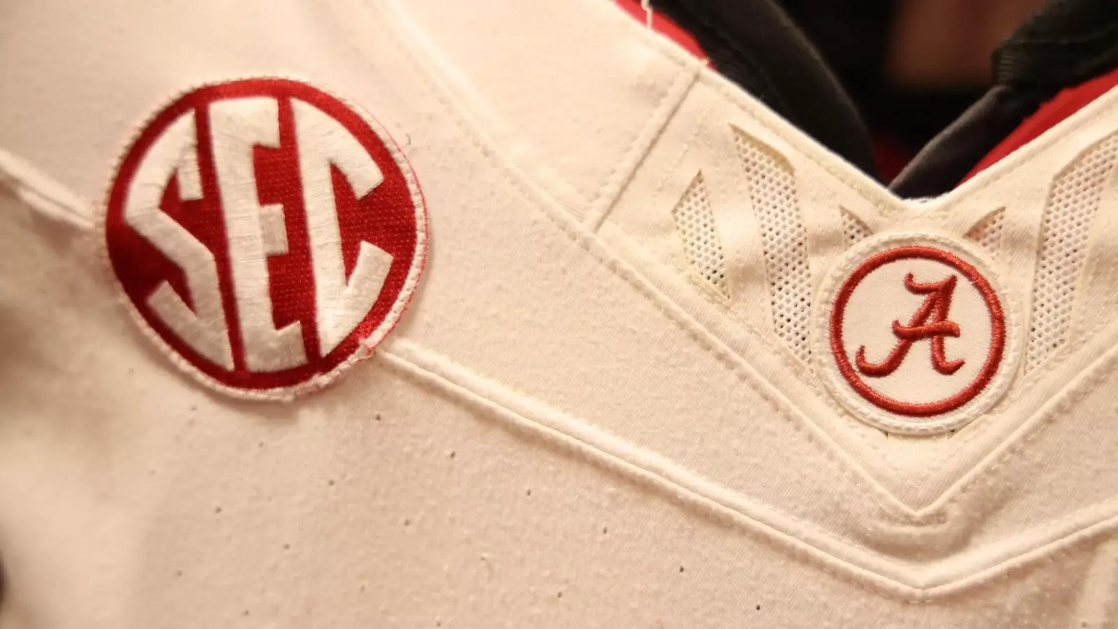 Footballs in front of a gym bag with Alabama on the side