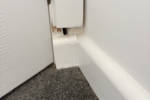 A skirting board with a gap to a door frame