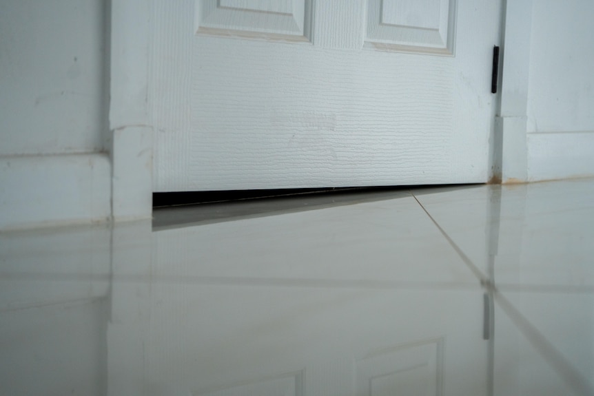 A white door with a triangle gap under it