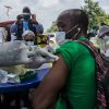 TOPSHOT - A health worker from the Guinean Ministry of Health cleans a suspected contact of an Ebola patient's arm ahead of administering an anti-Ebola vaccine in Gueckedou, Guinea, on February 23, 2021. - Guinea launched an Ebola vaccination campaign on February 23, 2021, after a fresh outbreak of the deadly disease struck the country this month, with officials hoping to eradicate the virus in six weeks.