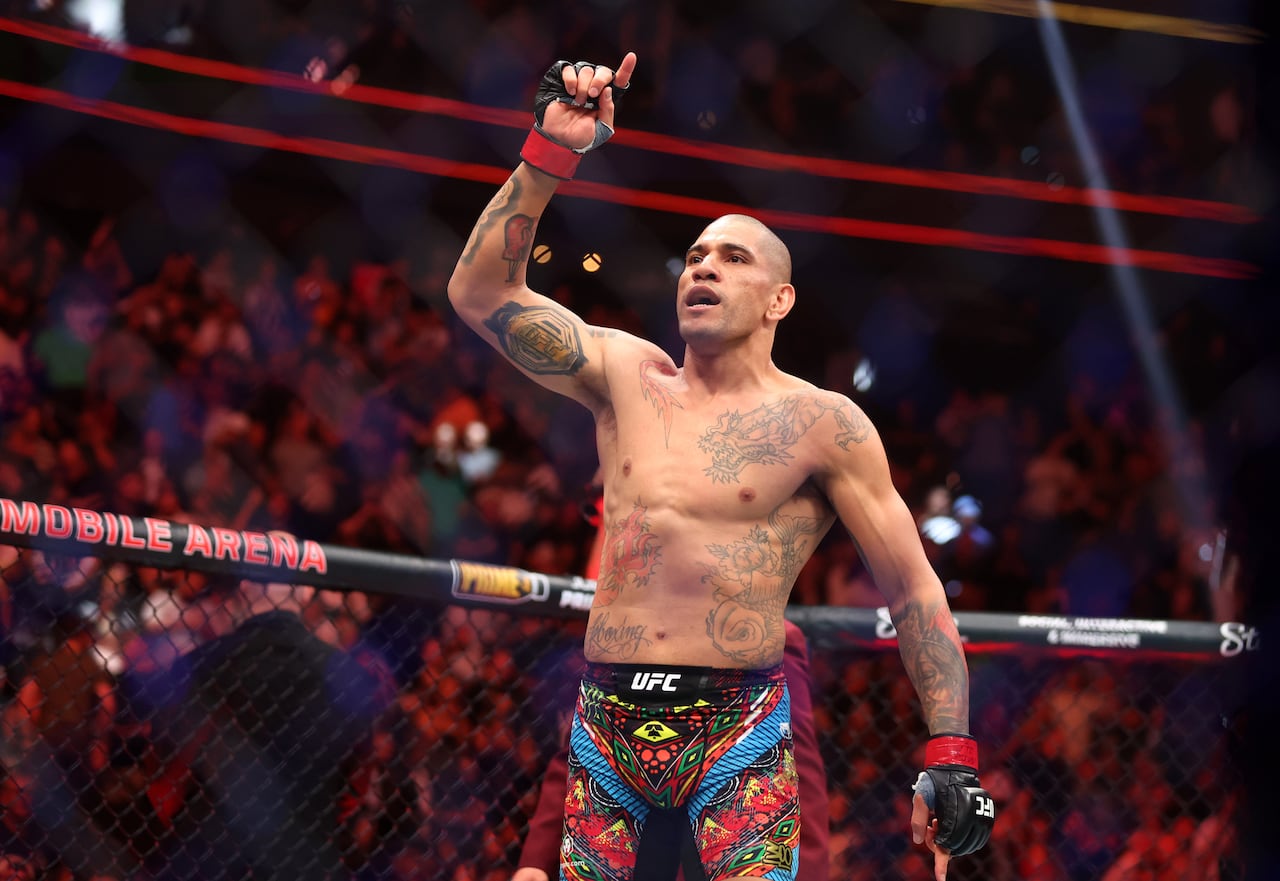 A mixed martial artist celebrates after winning a fight.