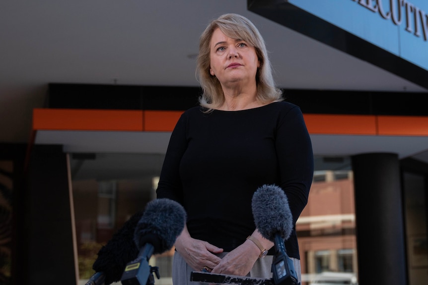 A blonde politician at a press conference.