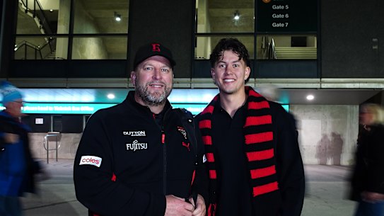 Essendon fan Christopher Klose with his son Jordan outside the MCG.