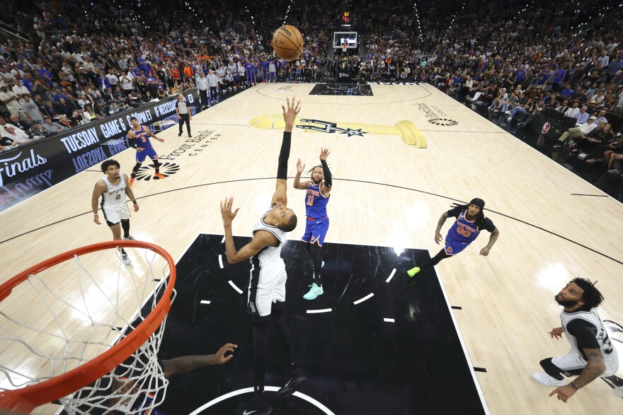 Jun 13, 2026; San Antonio, Texas, USA; New York Knicks guard Jalen Brunson (11) makes a jump shot over San Antonio Spurs forward Victor Wembanyama (1) during game five of the 2026 NBA Finals at Frost Bank Center.