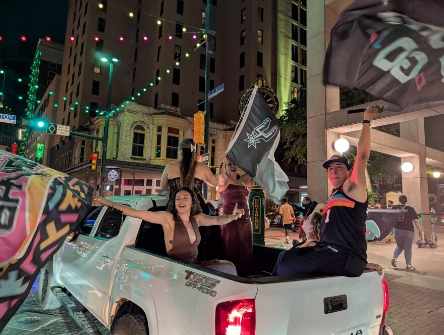 Spurs fans celebrate on Commerce Street following the Spurs' Game 7 victory over the Oklahoma City Thunder. The win sent San Antonio to the NBA Finals and sparked celebrations across the city.
