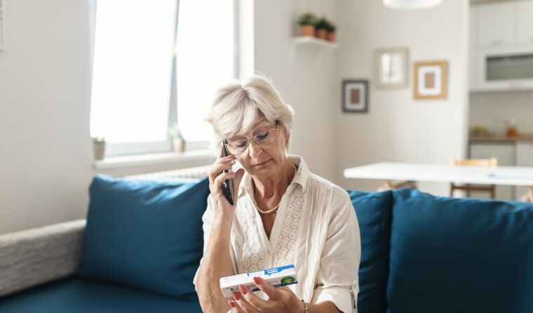 Woman getting medication advice by phone.