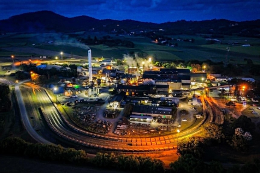 An aerial view of a sugar mill at night.