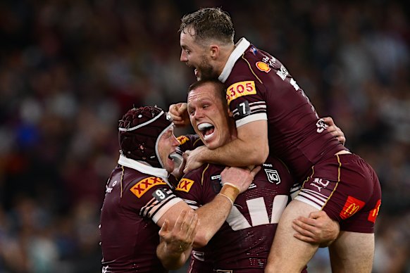 Lindsay Collins celebrates a try with Sam Walker and Harry Grant.