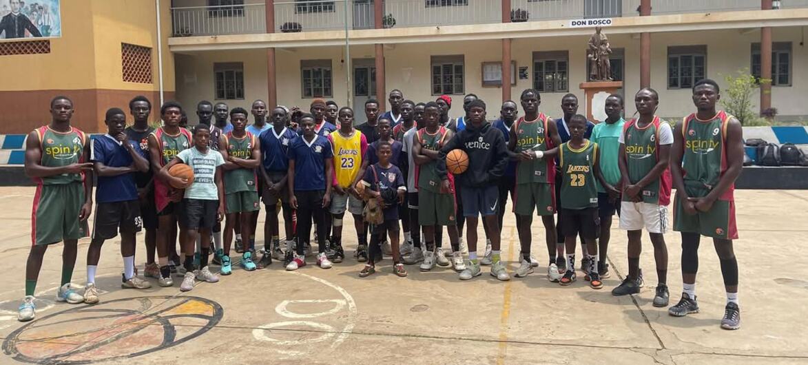 The refugee basketball players line up for a team photo.