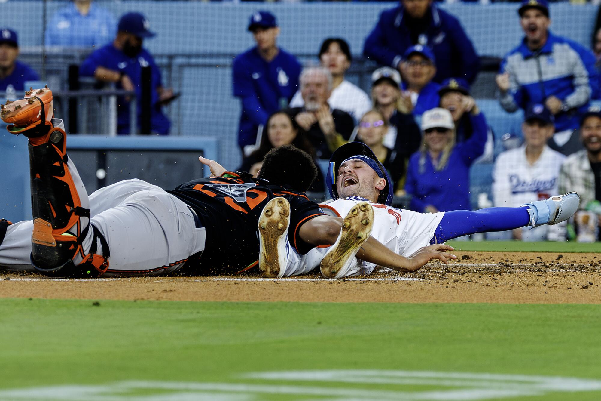 Alex Freeland signals safe after sliding past Baltimore catcher Samuel Basallo to score on a double by Andy Pages.