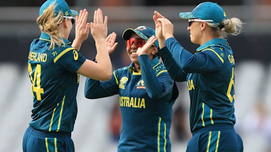 Australia’s Ashleigh Gardner, right, celebrates with teammates Alana King and Annabel Sutherland, left, after taking the wicket of South Africa’s Nonkululeko Mlaba to win the game during the Women’s T20 World Cup match between Australia and South Africa at Old Trafford, Manchester, England, Saturday June 13, 2026. (Nigel French/PA via AP)