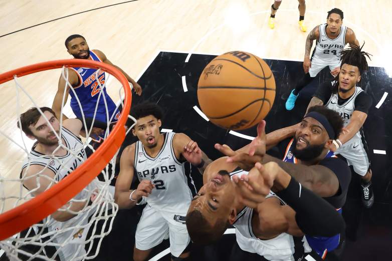 New York Knicks center Mitchell Robinson and San Antonio Spurs star Victor Wembanyama compete for a rebound under the basket during Game 5 of the 2026 NBA Finals in San Antonio.