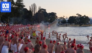 Nude swimmers take chilly plunge in Dark Mofo solstice swim