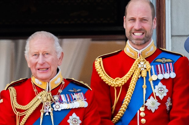 King Charles III and Prince William, Prince of Wales watch an RAF flypast from the balcony of Buckingham Palace during Trooping The Colour on June 13, 2026