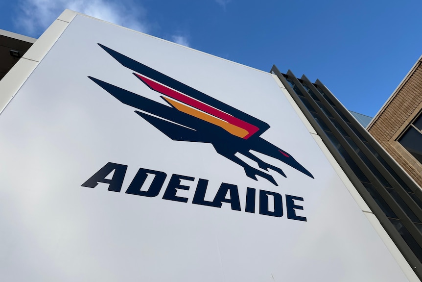 A sign with the Adelaide Crows logo on it.
